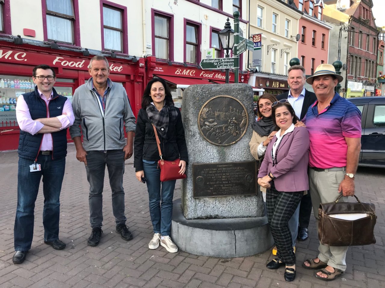 people standing beside stone monument on street 