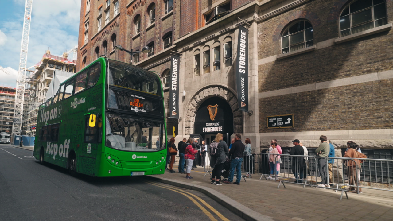 the front and side of the hop on hop off bus at the guinness storehouse
