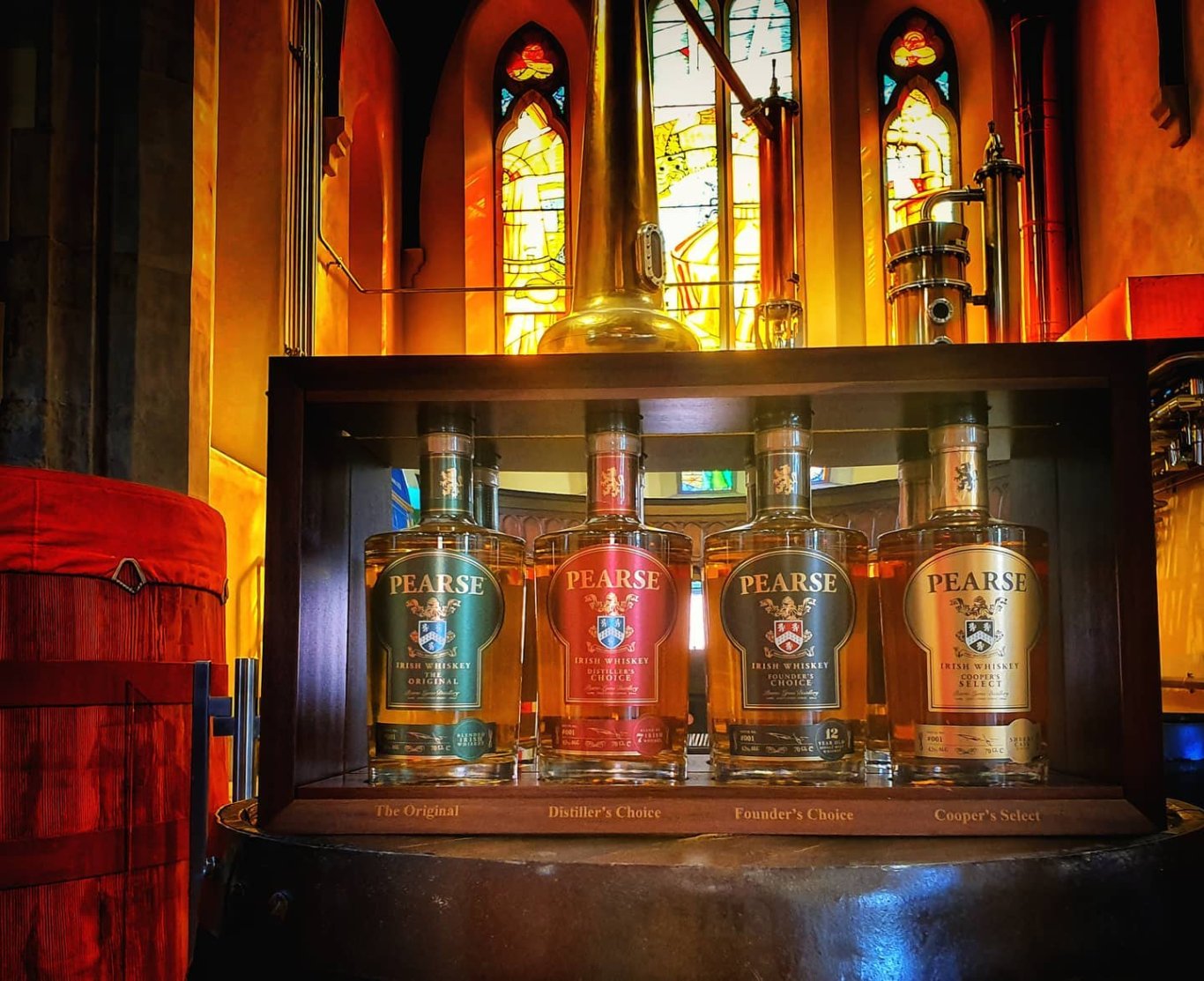 Pearse Lyons Whiskey Range Four bottles of Pearse Lyons Irish Whiskey on whiskey barrel in Pearse Lyons Distillery