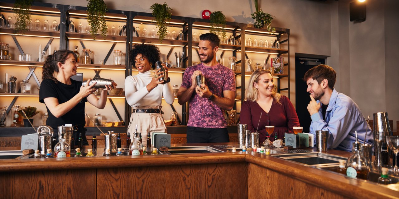 visitors try mixing cocktails at irish distillery