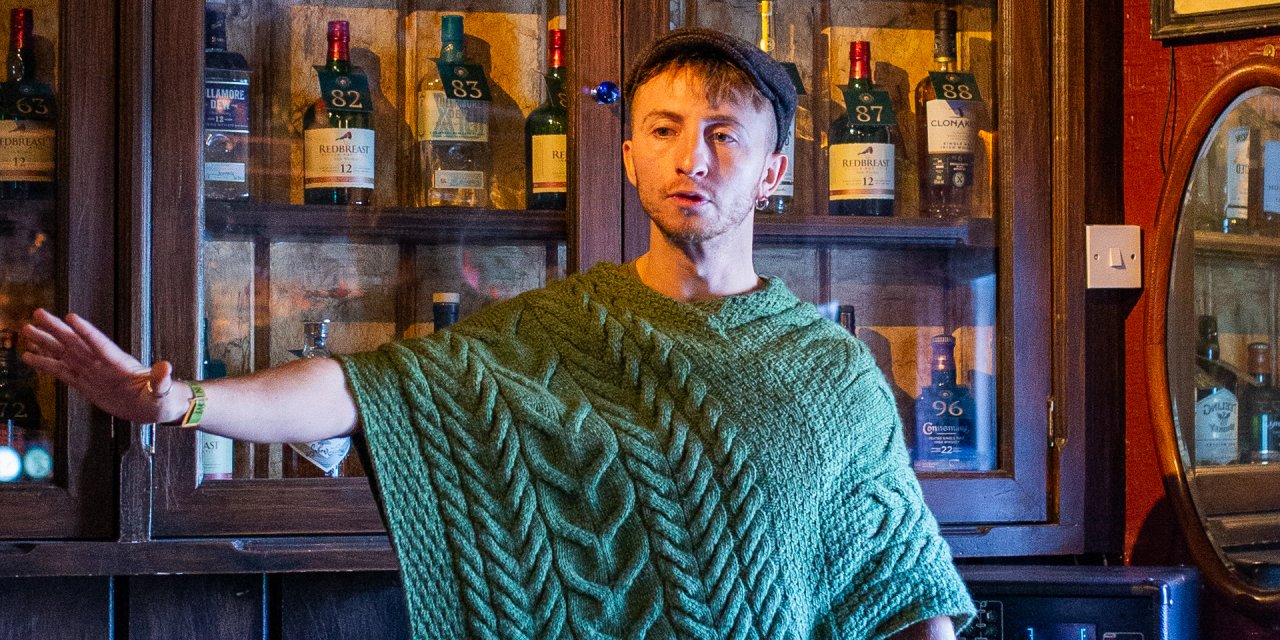 Sean Cuddy telling a story wearing a hat and poncho